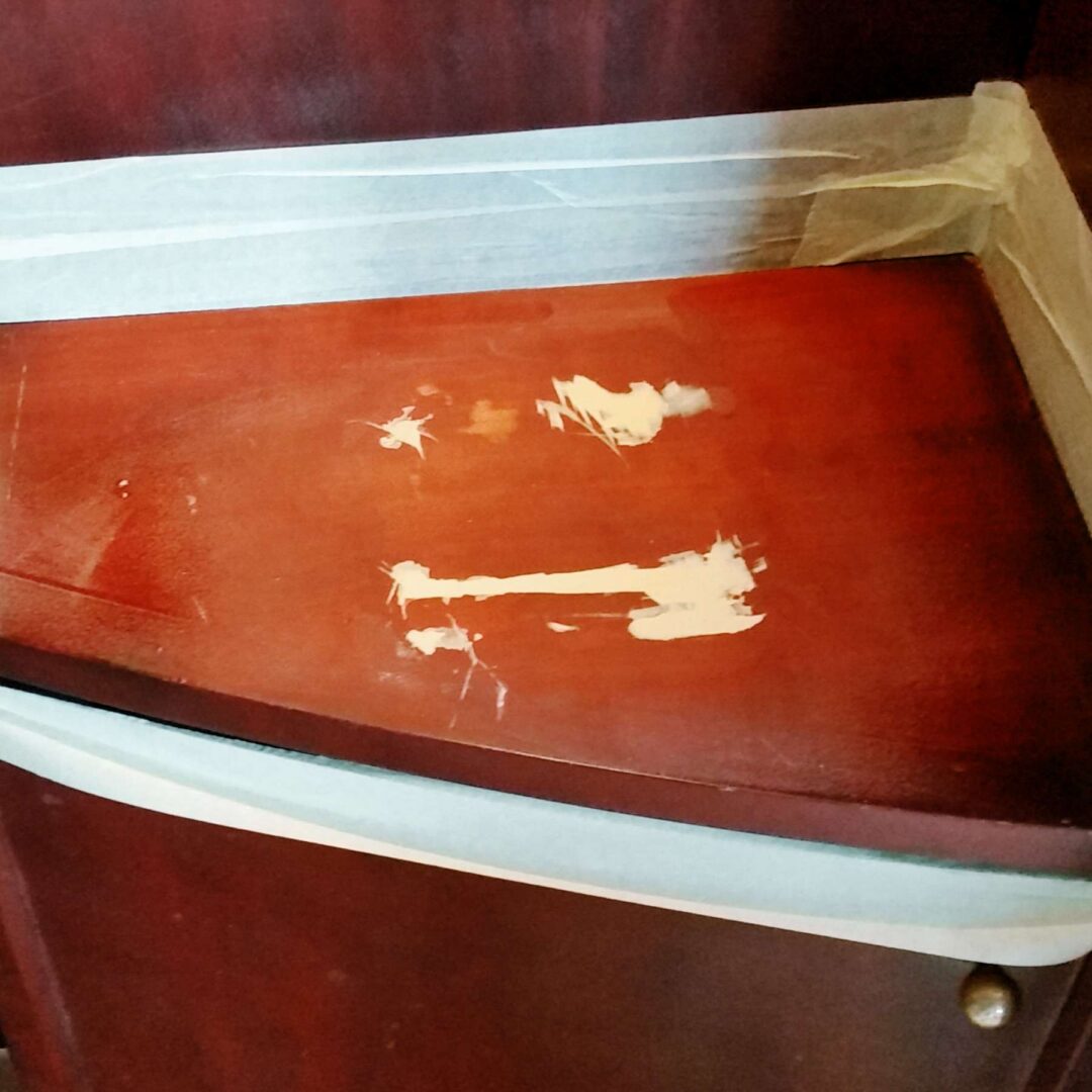 Before: Paint-Splashed Mahogany Cabinet Top Restored
