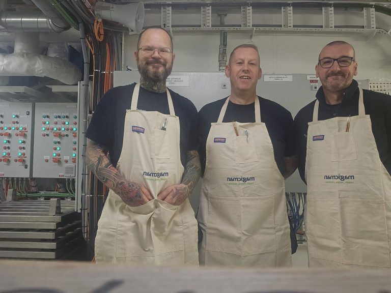 a group of men wearing aprons