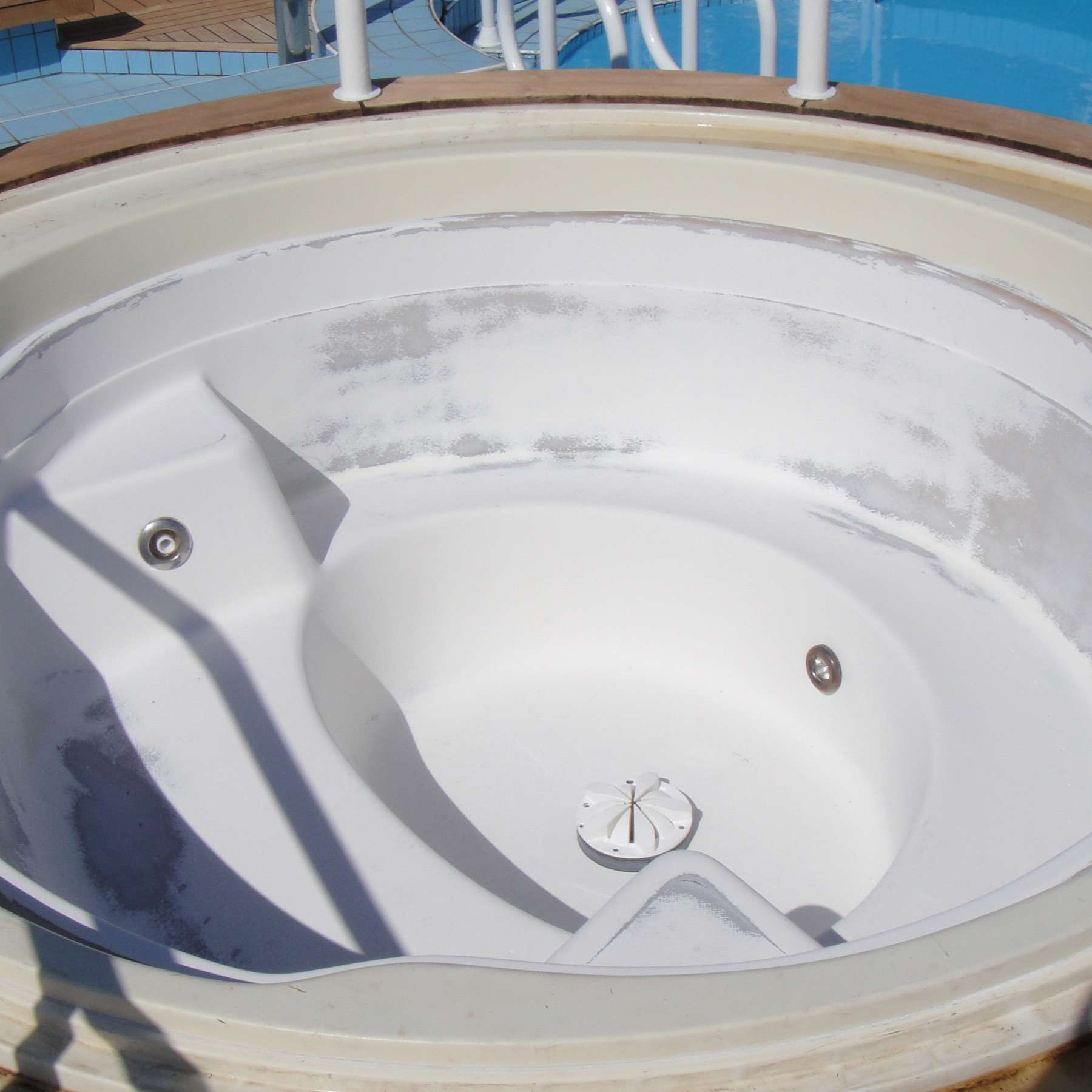 Before: Faded Poolside Whirlpool Spa Resurfaced to Gloss White